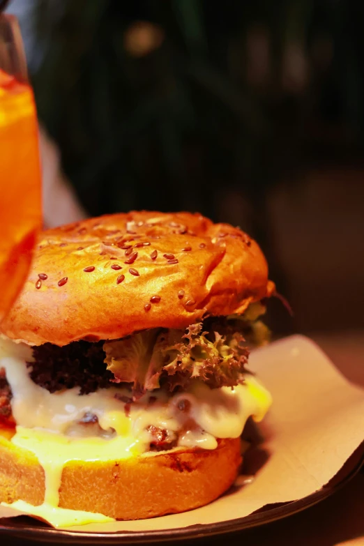 a sandwich is sitting on top of a plate with a beverage