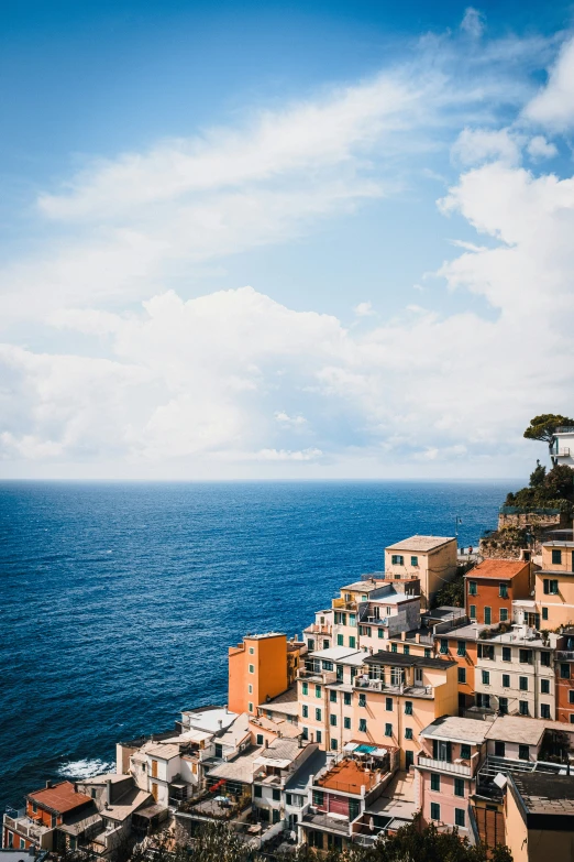 houses overlooking the ocean on a cliff above them