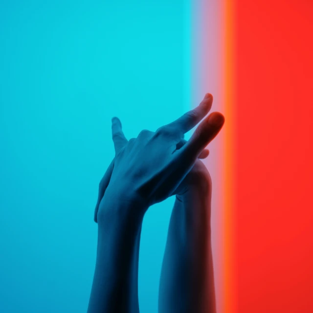 a person touching a multi colored wall