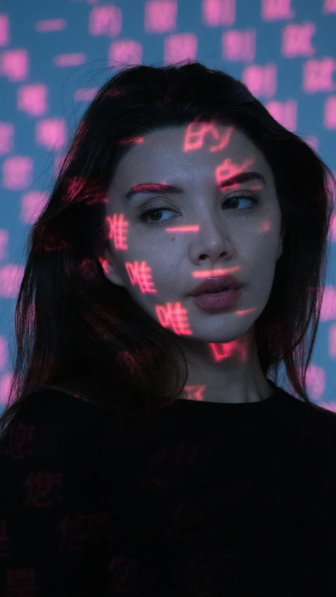 the woman is standing underneath a colorful background