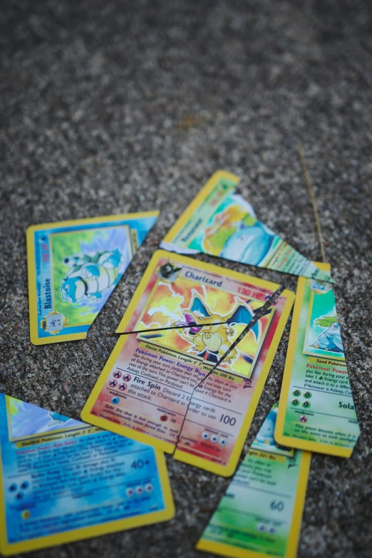 these pokemon trading cards are lying on the ground