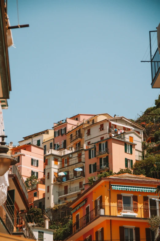 an apartment building stands on a hillside