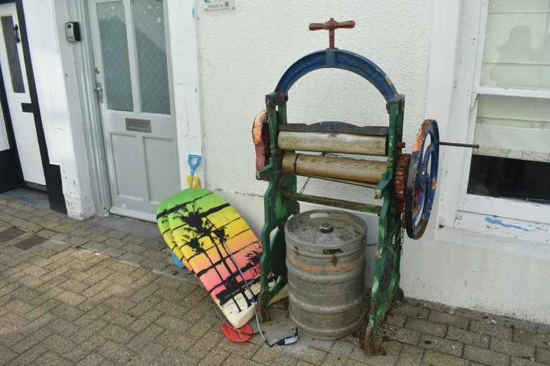 two wood turning wheels sitting next to a building