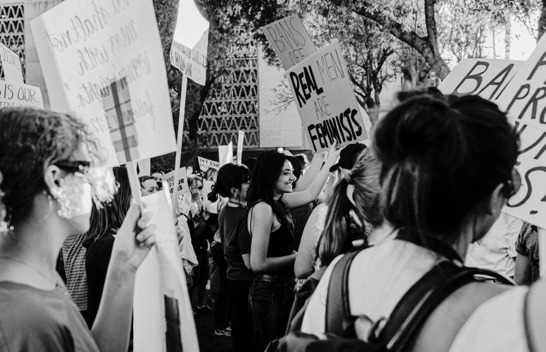 black and white pograph of people holding protest signs