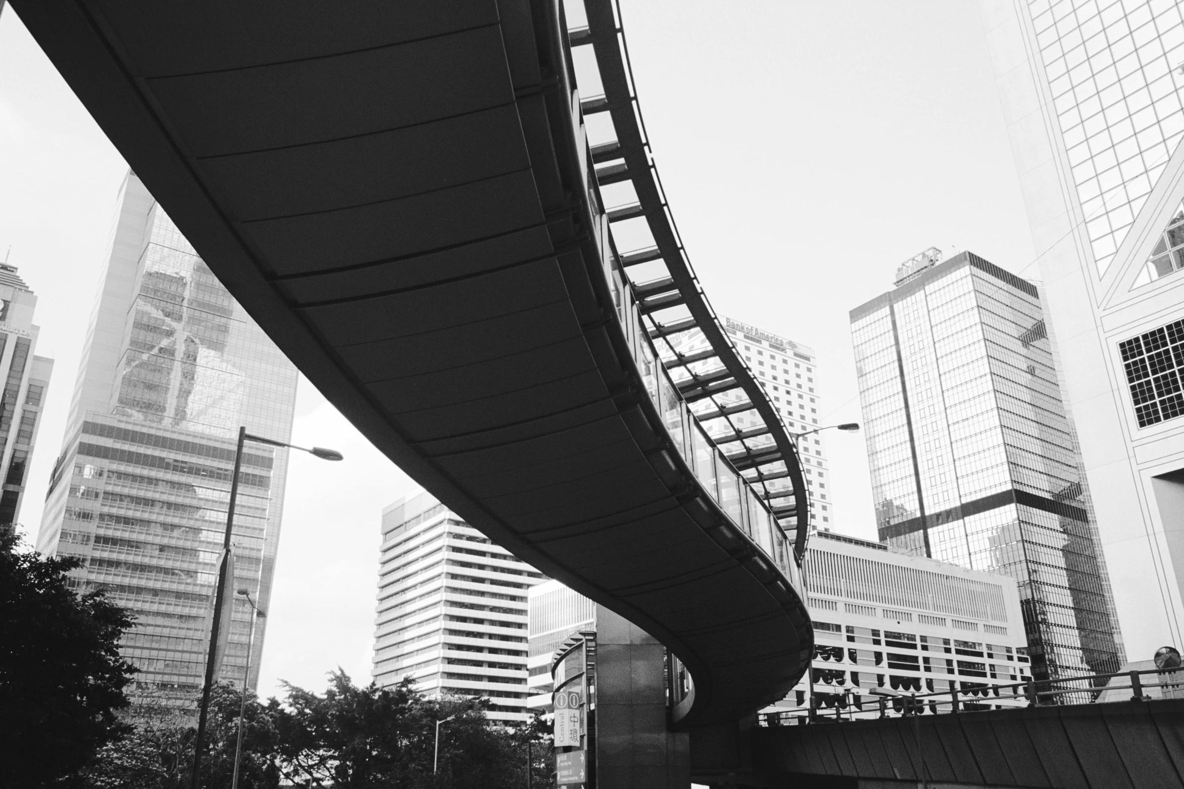 there is a man walking down the street on a bridge