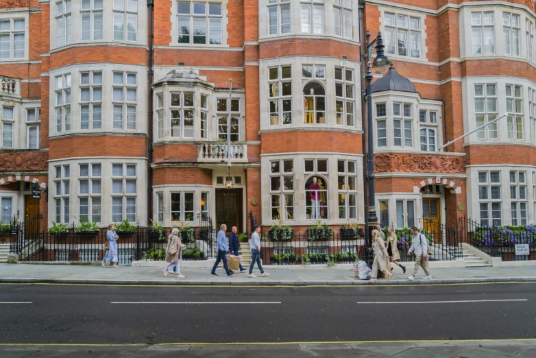 several people walking around on a city street