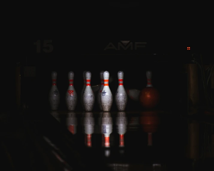 some bowling pins on the ground with reflections