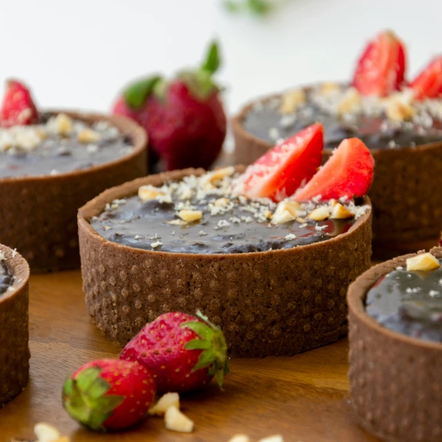 some chocolate cakes with strawberries and nuts