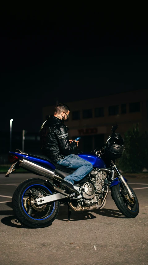 a person wearing a jacket is sitting on a motorcycle