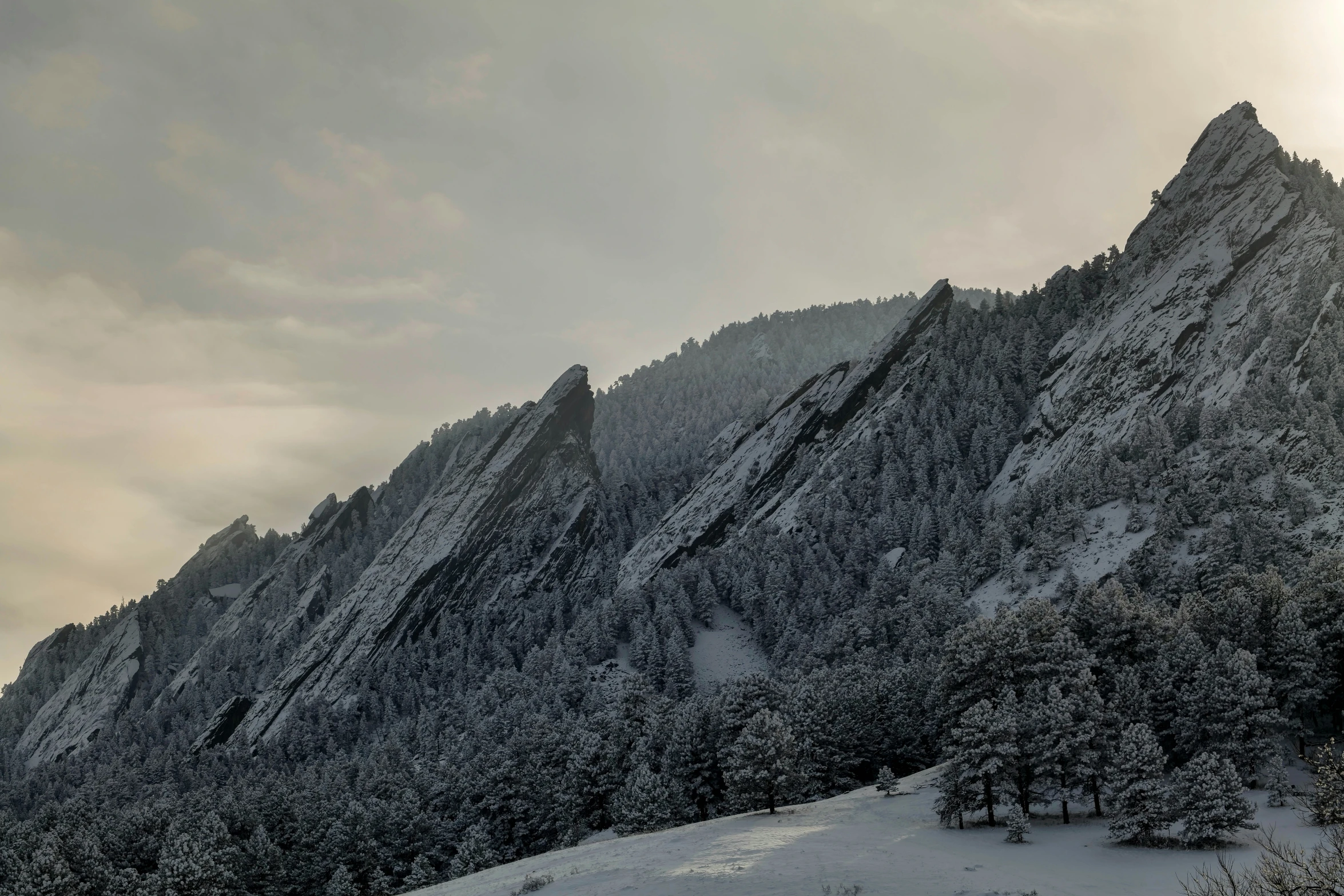 a mountain view covered in snow during winter