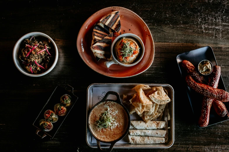 a number of different plates with foods on a table