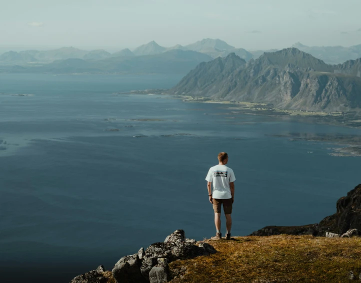 a man stands on the edge of a cliff