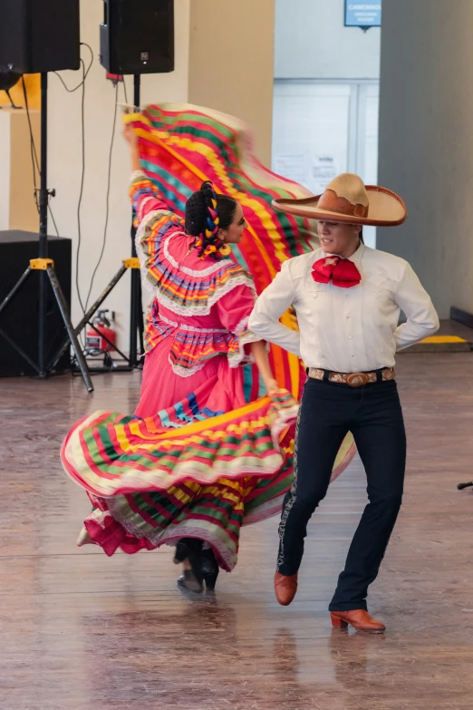 a man and woman are dancing in a ballroom