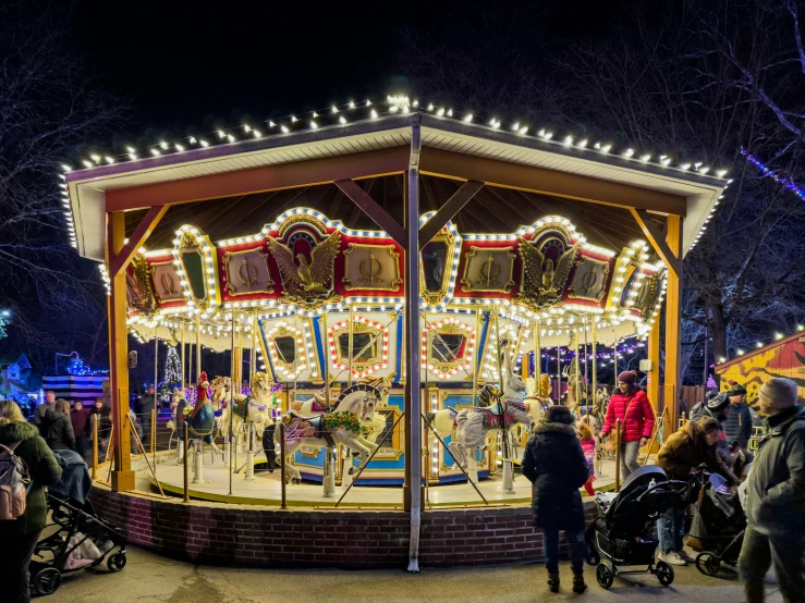 people gather around a merry go round