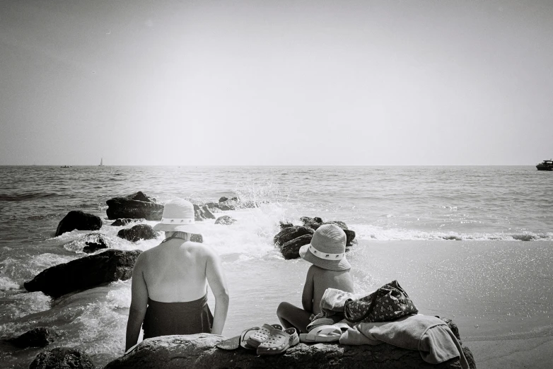 two people on a beach near the water