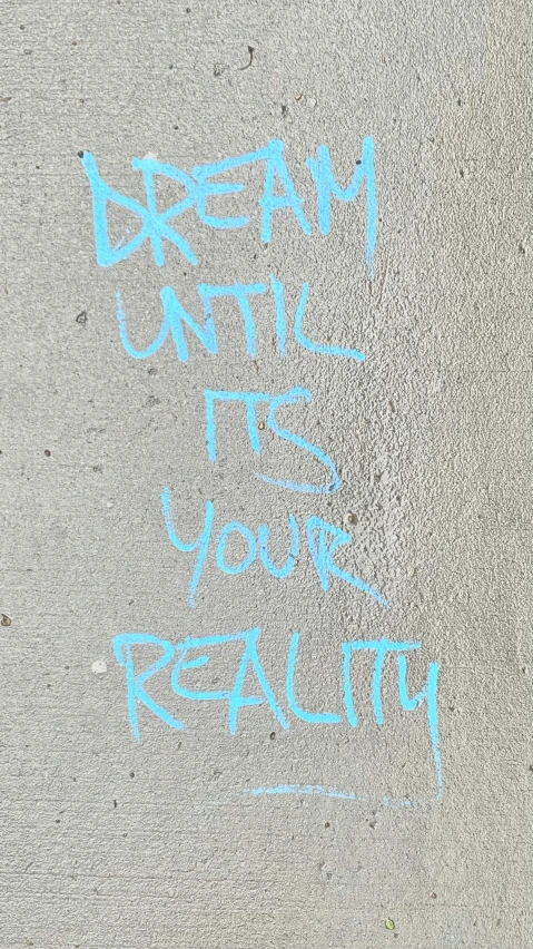 the word dream on a street wall and the words, your in