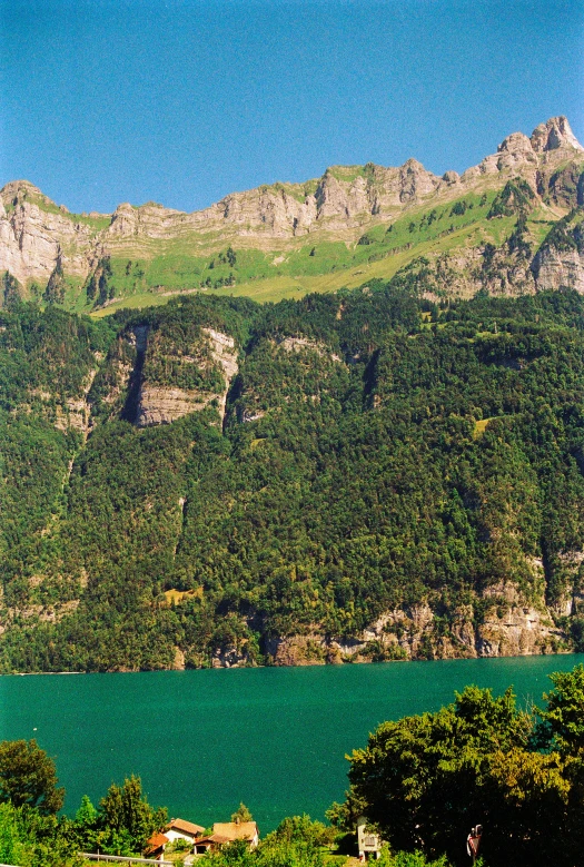 a house in the foreground next to a lake