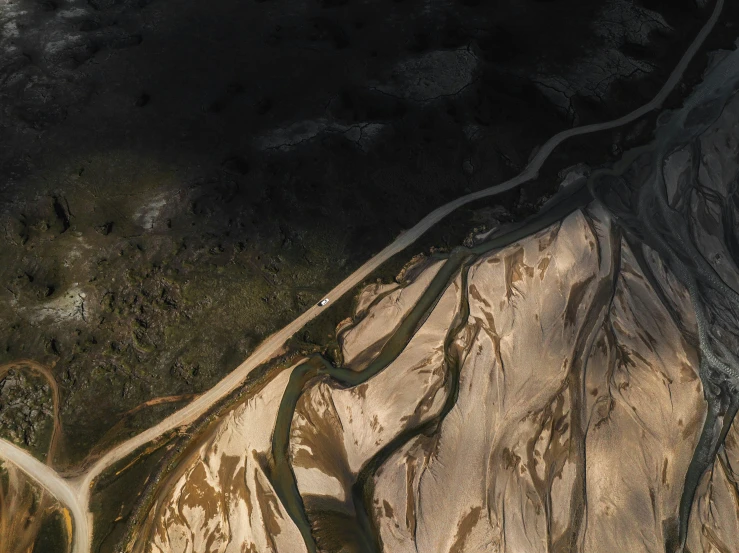 an aerial s of a river running through the mountains