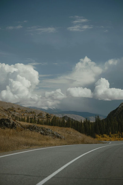 the view from the side of the car as it drives down a mountain road