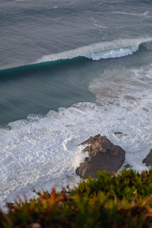 a white wave is coming in onto the water