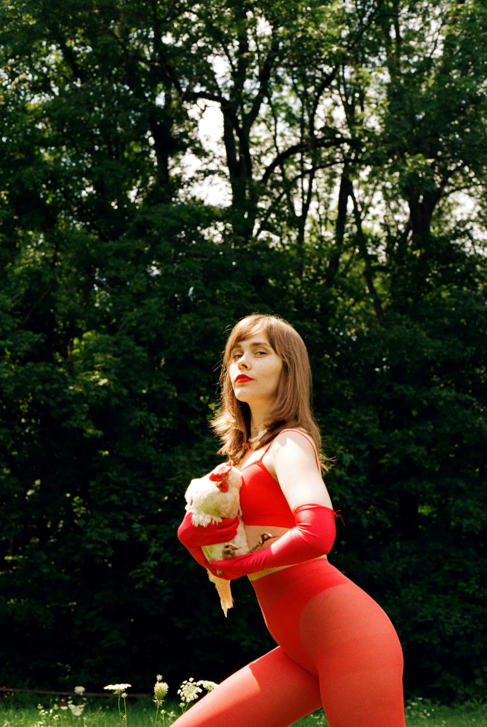 a woman in red tights and white panties posing for a picture