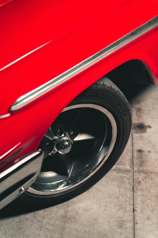 a close up of a car tire in a parking space