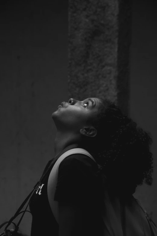 woman looking up with a backpack on her back