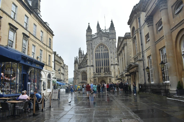 people walk down an alley way in the rain