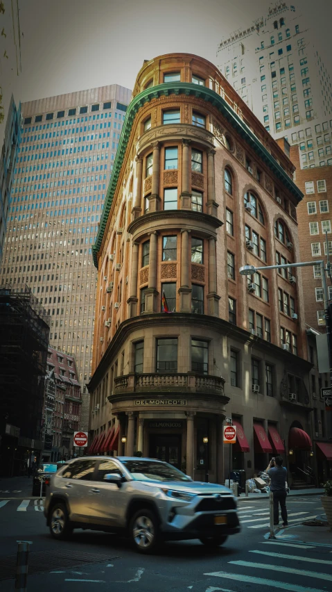 a car driving down a street near buildings