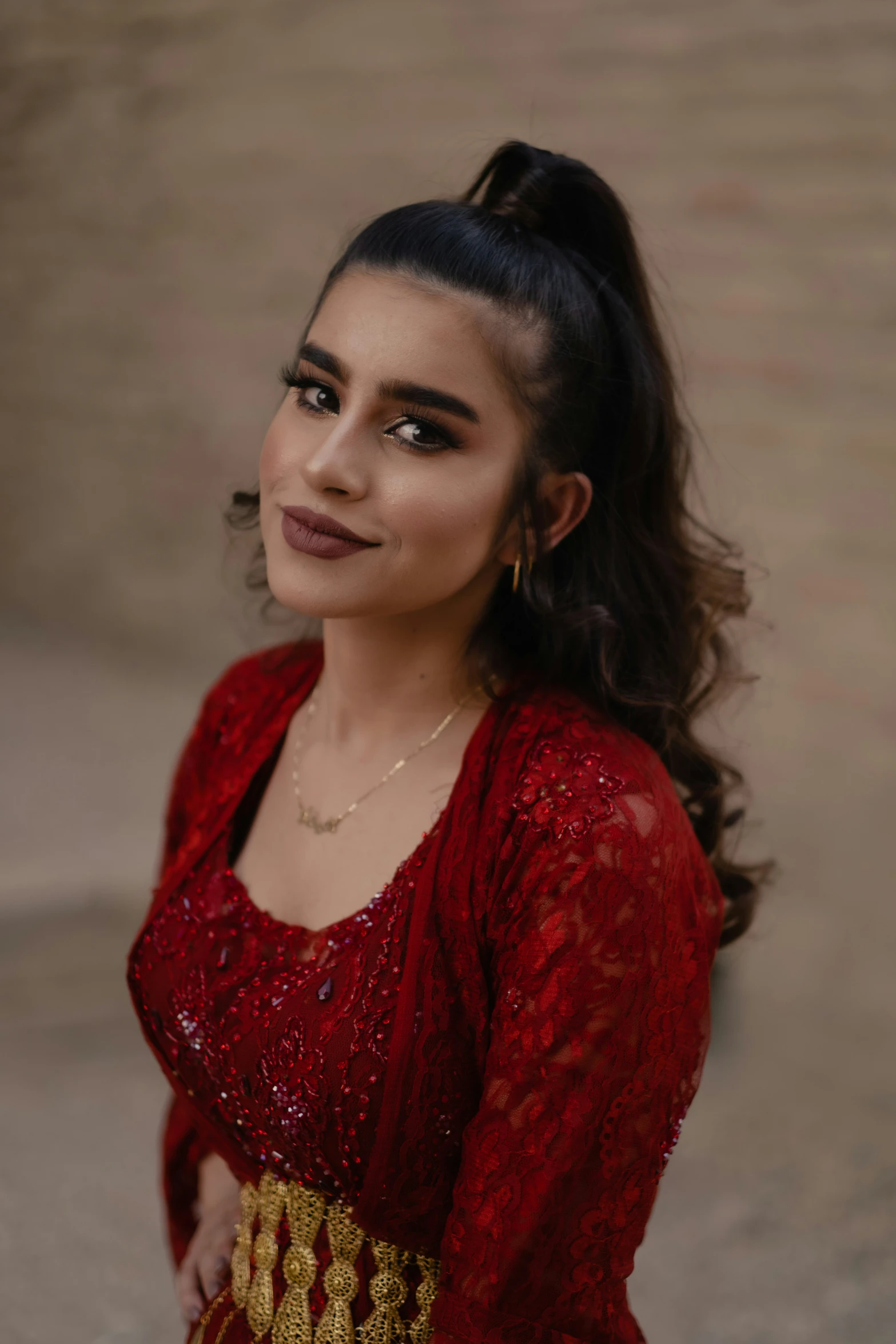 a beautiful young woman standing outside with a smile