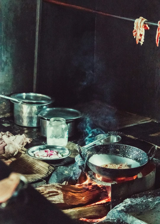 a man cooking food inside of an old kitchen