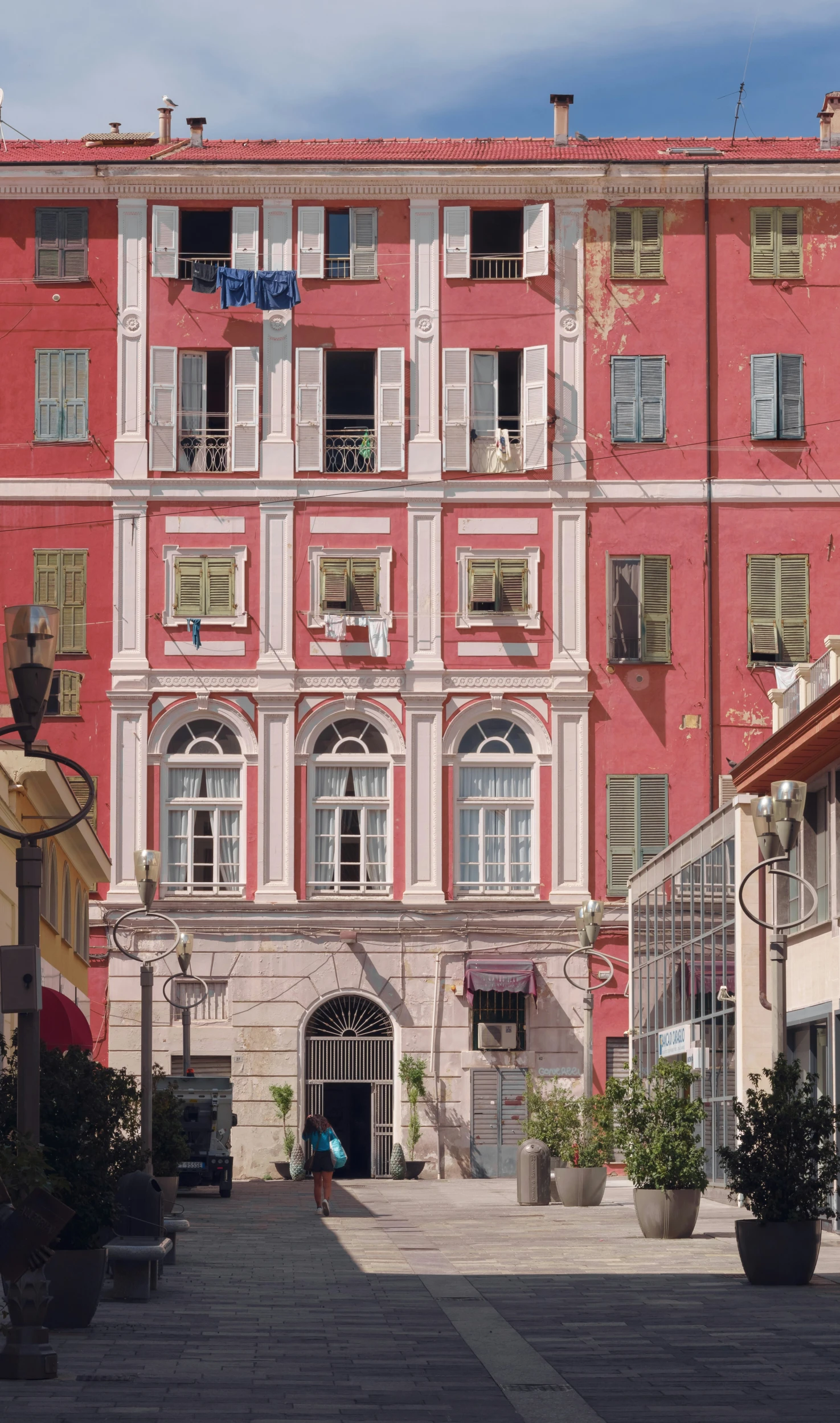 a building in italy with white shutters and a clock