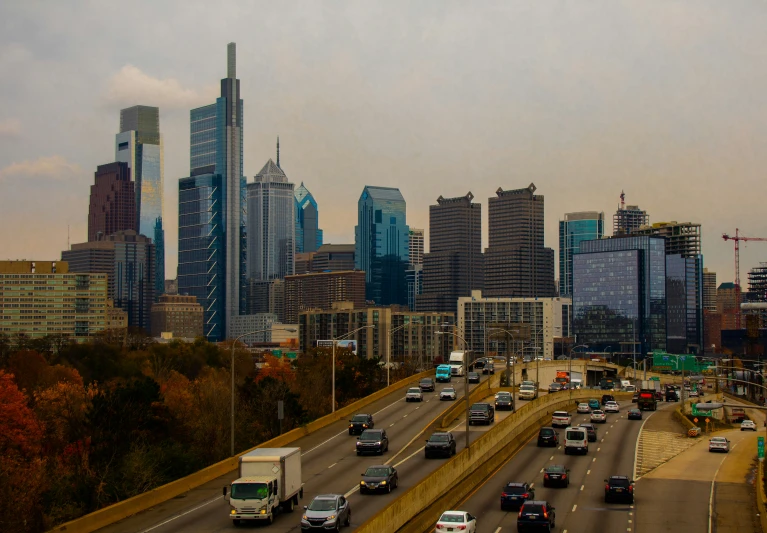 cars are driving down an elevated highway towards the city