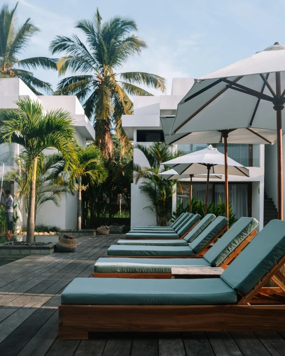 lounge chairs are set out in front of a resort building