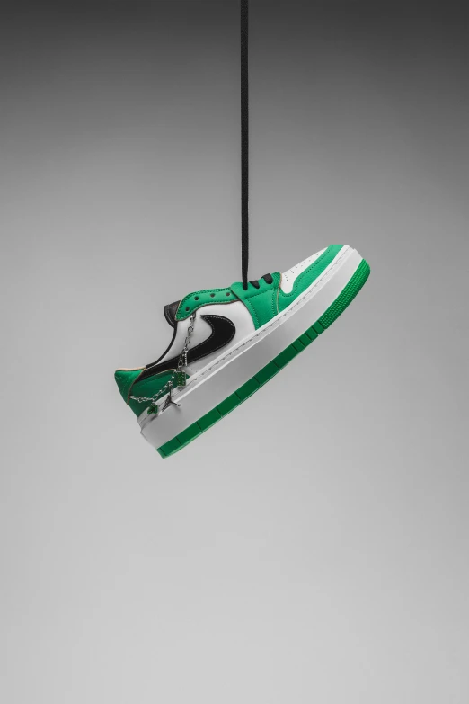 a pair of sneakers hanging from a wire with string attached to the string