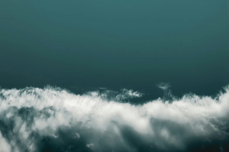 a plane flying over a bunch of clouds