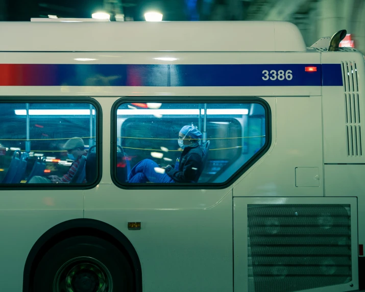 a person sitting in a bus in the night