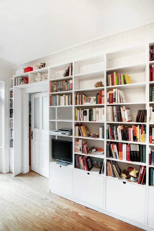 a liry of books are arranged on the wall