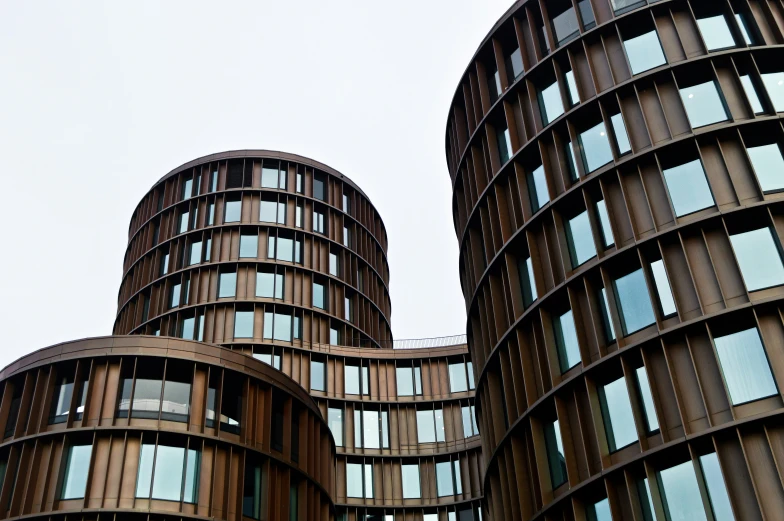 some very tall brown buildings with windows and sky