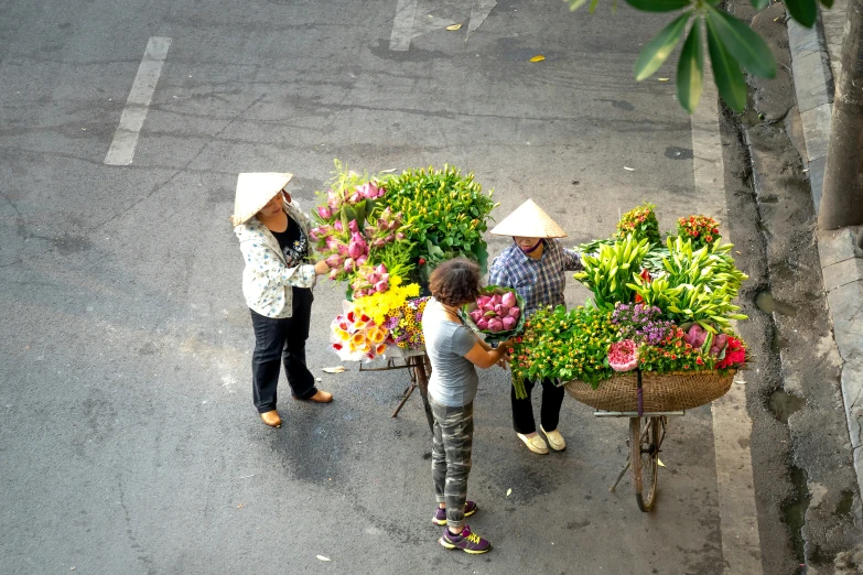 an aerial view of three women with baskets on their heads