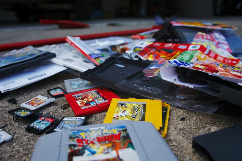 a pile of video game cases and games sitting on the floor