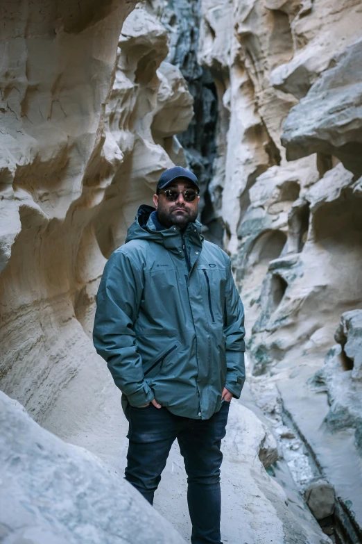 a man standing in the middle of a trail surrounded by rocks