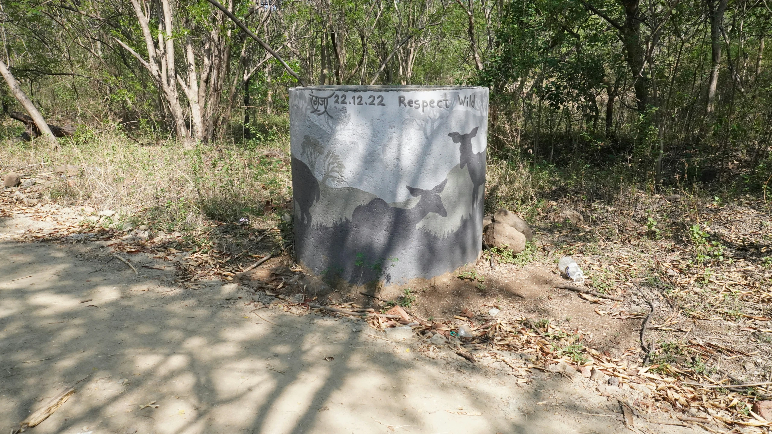 the concrete marker reads city hall and a trail