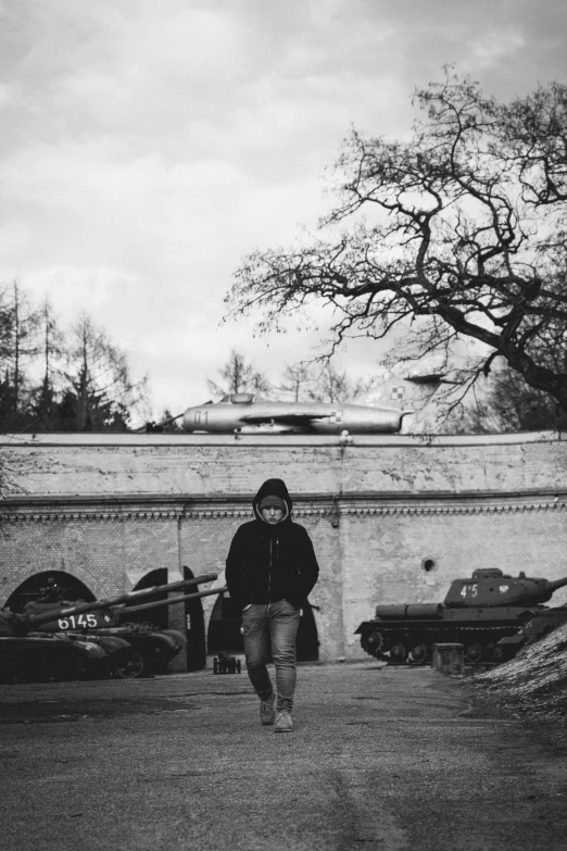 a man sitting on the ground in front of a wall