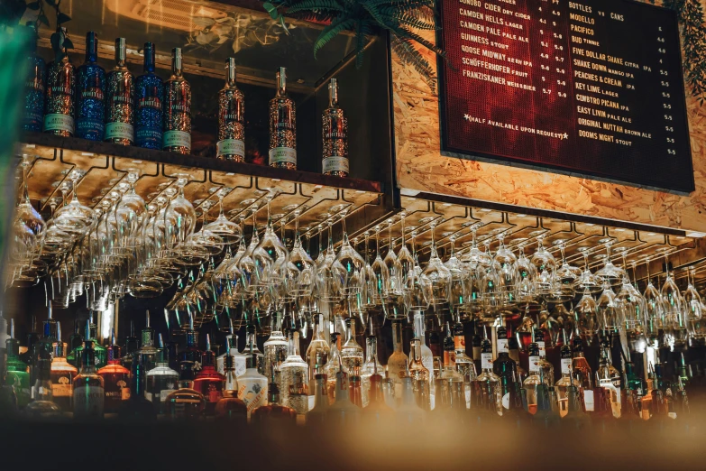 a bar with a bunch of liquor bottles hanging on the ceiling