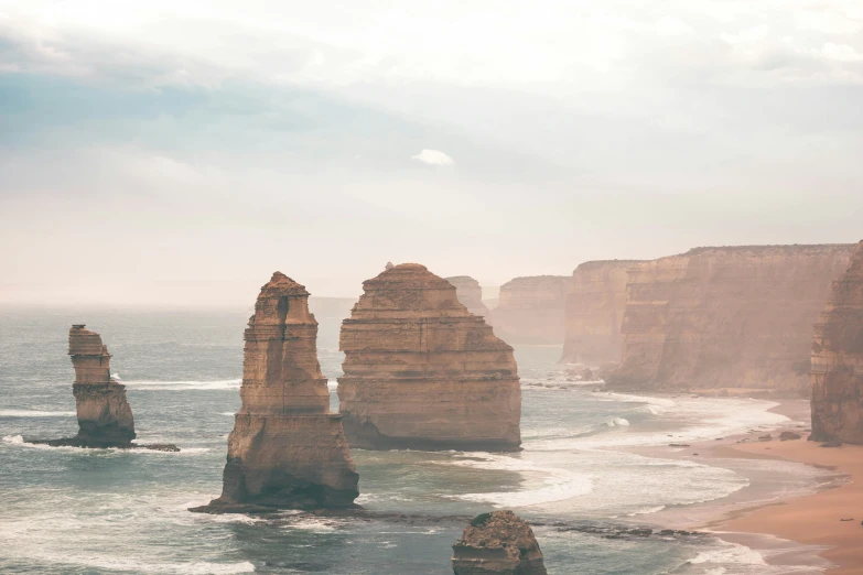 four tall rocky towers sticking out of the ocean