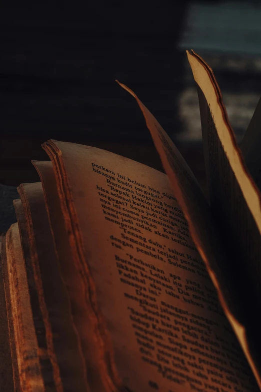 the open book is slightly opened and sitting on top of a table