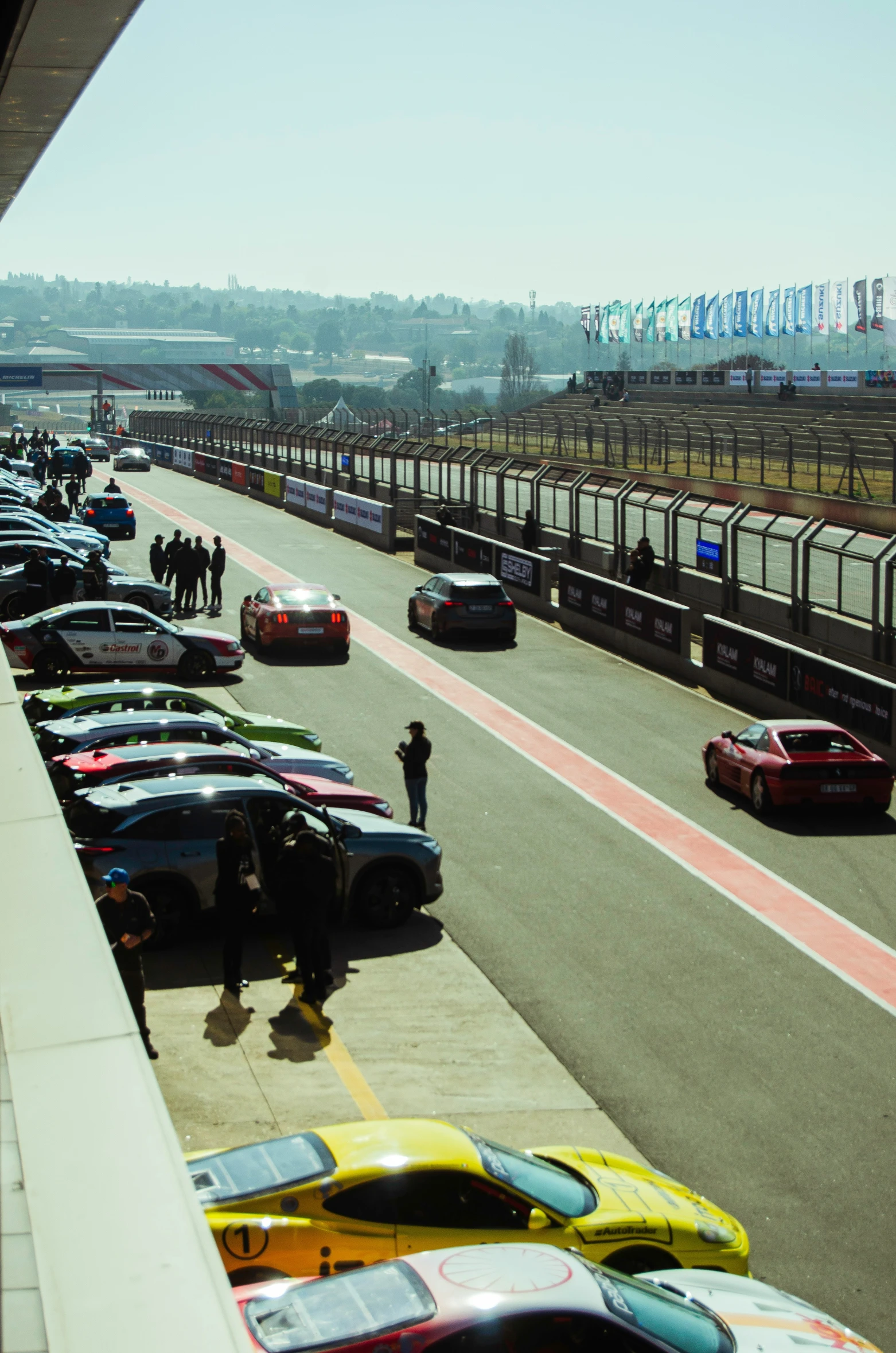 several cars are parked in a lot as pedestrians look on