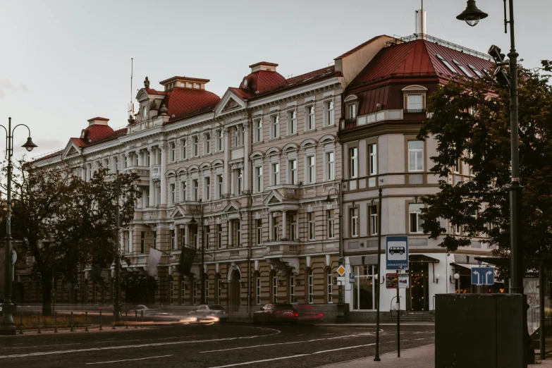 an old, large building stands next to the street