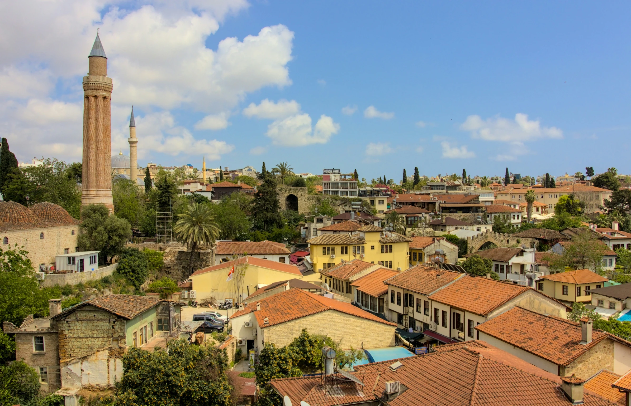 a city with a tower surrounded by lots of trees